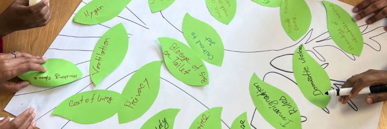 Poster of a tree with people placing leaves onto it, each leaf has writing on it.