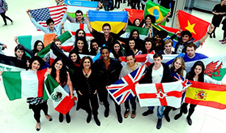 group of people holding various flags of countries