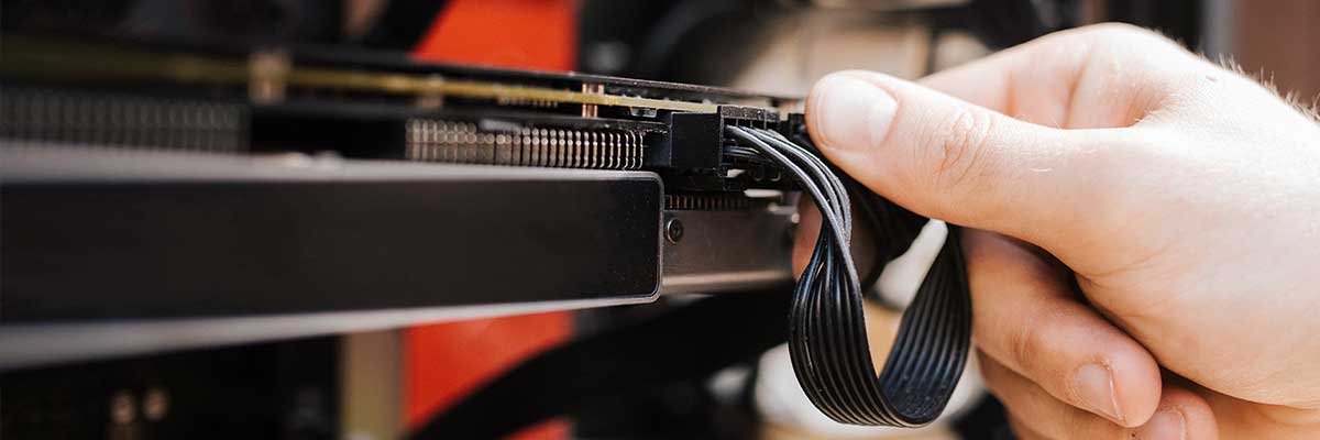person connecting computer cables