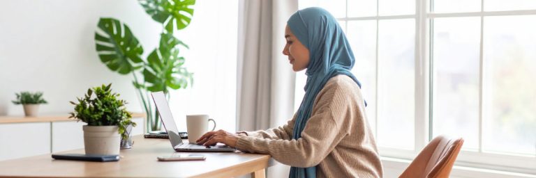 Person practising basic Excel skills for work on a laptop at a home desk.