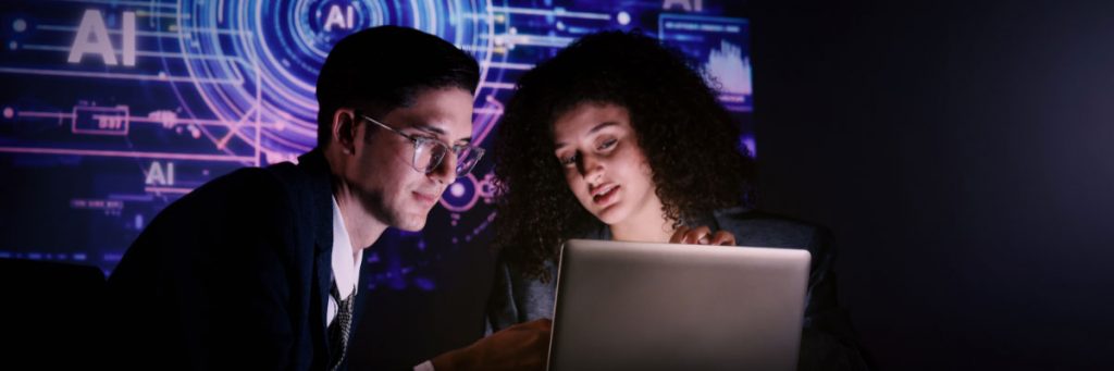 Two people looking at a laptop together.