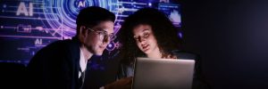 Two people looking at a laptop together.