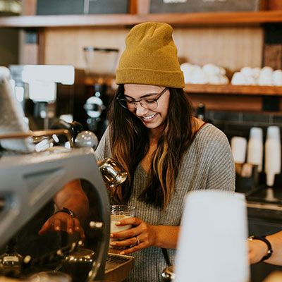 happy-female-barista-making-coffee
