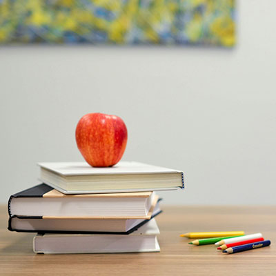 books-crayons-letters-apple-on-desk