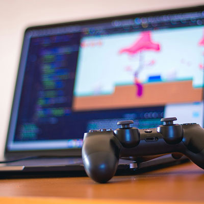 laptop-with-game-development-software-and-controller