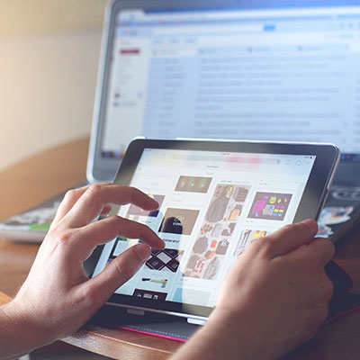 person-using-tablet-in-front-of-desk