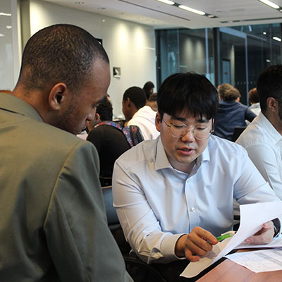 male-worker-discussing-with-young-male