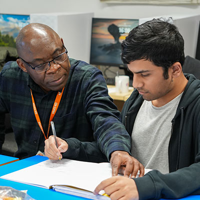 young-male-student-working-with-male-adult