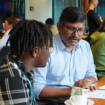 male-worker-discussing-with-young-male